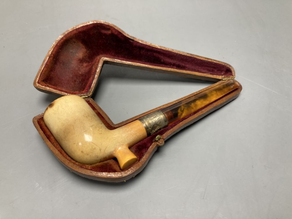 A silver-mounted Meerschaum pipe and two cut-throat razors, all cased